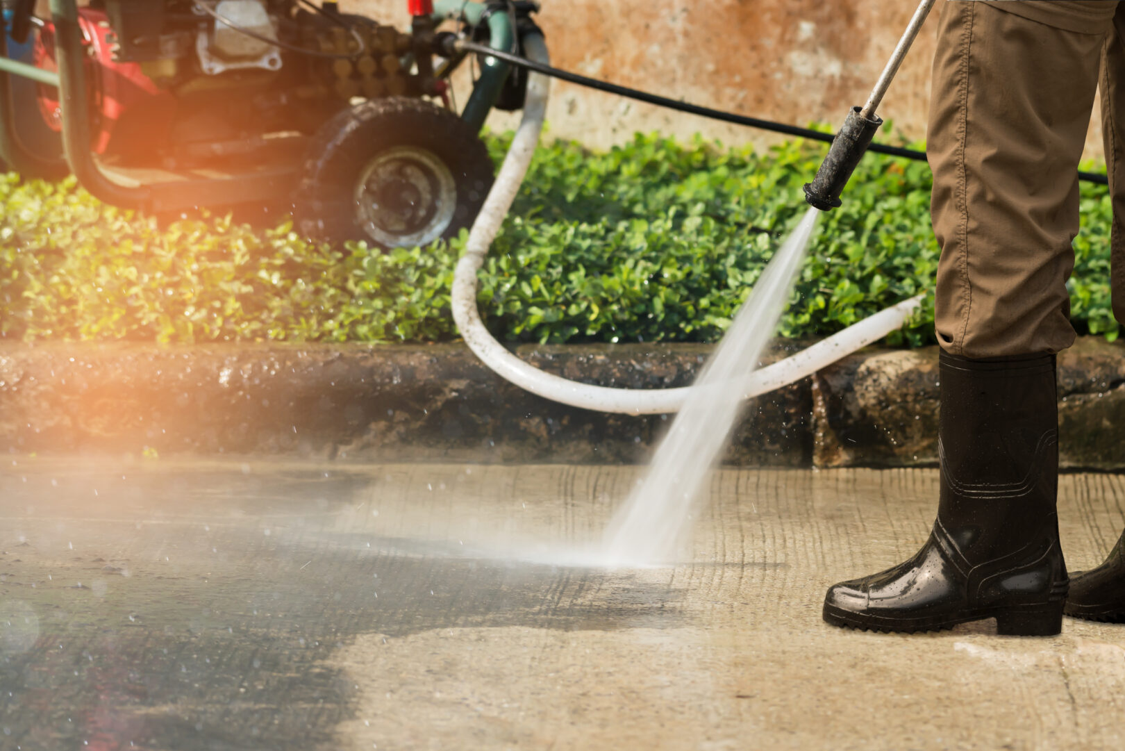 Professional pressure washing a driveway