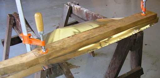 Making a homemade rain diverter from sheet metal.