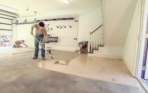 Men install an epoxy floor in a garage