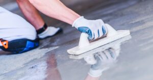 man sealing concrete floor
