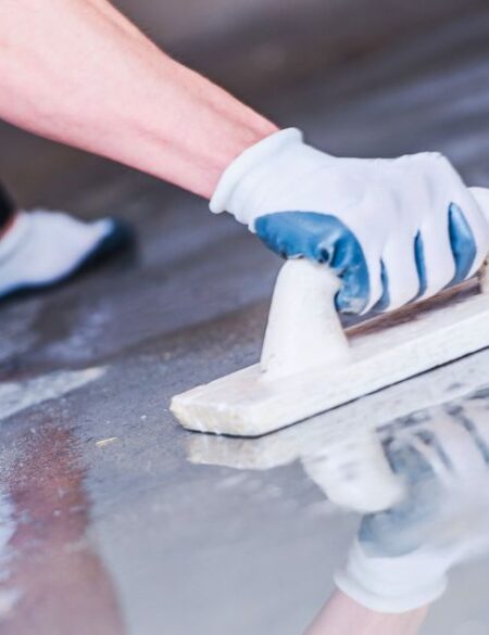 man sealing concrete floor