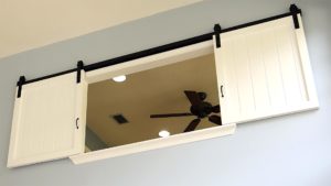 white sliding interior shutters on a track revealing a loft