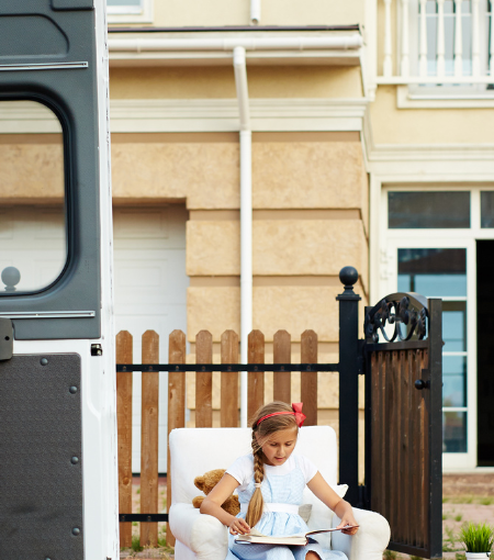 A family of four carries moving boxes for a move in Tennessee