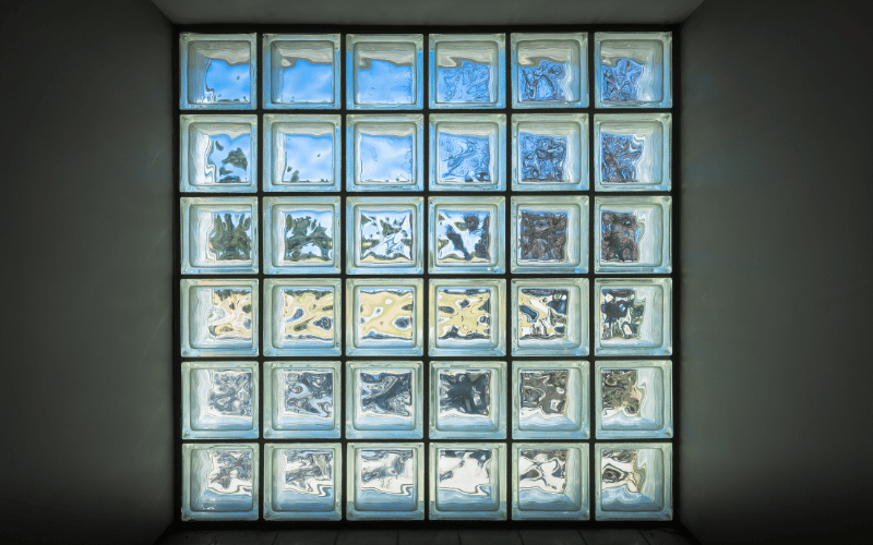 Interior wall with a glass block window allowing light in 