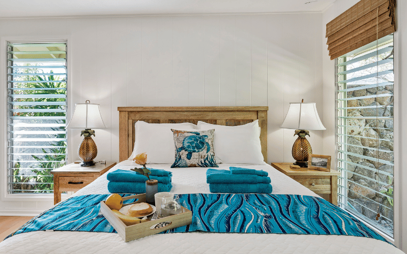 Nautical-themed bedroom with jalousie windows