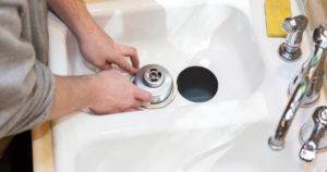 Man working on garbage disposal